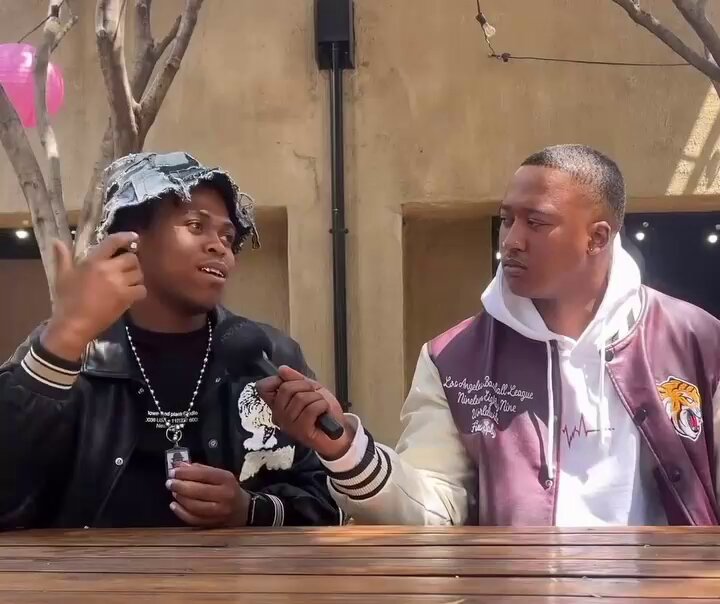 uSimamane sits with this unknown man as he reveals that he is a big A-Reece fan and he doesn't think he'll ever diss him regardless of A-Reece having thrown a couple of shots at him in his new single 'Mad'.