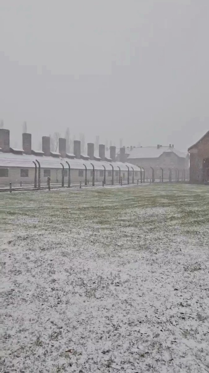 The former Auschwitz I camp. The fences of the prisoner compound and the 'Arbeit macht frei' gate area.