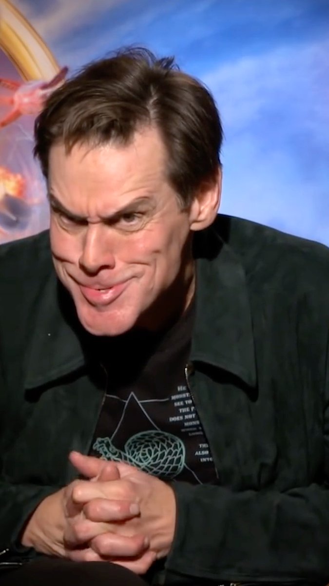 Jim Carrey doing his iconic Grinch face on the spot. (🎥: Rotten Tomatoes 🍅)