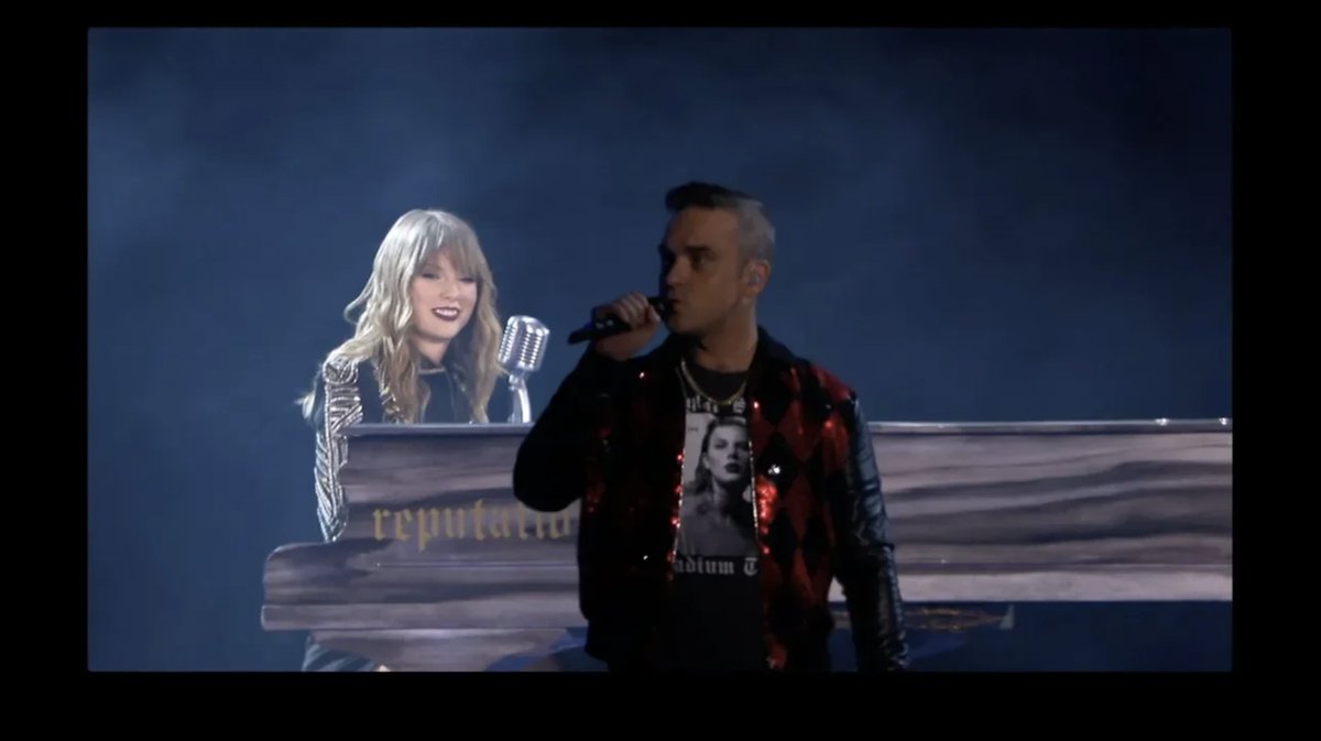 for uncultured ones this is taylor and robbie williams performing angels