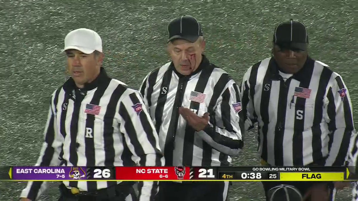 A ref took a helmet to the face during a scuffle between East Carolina and NC State.