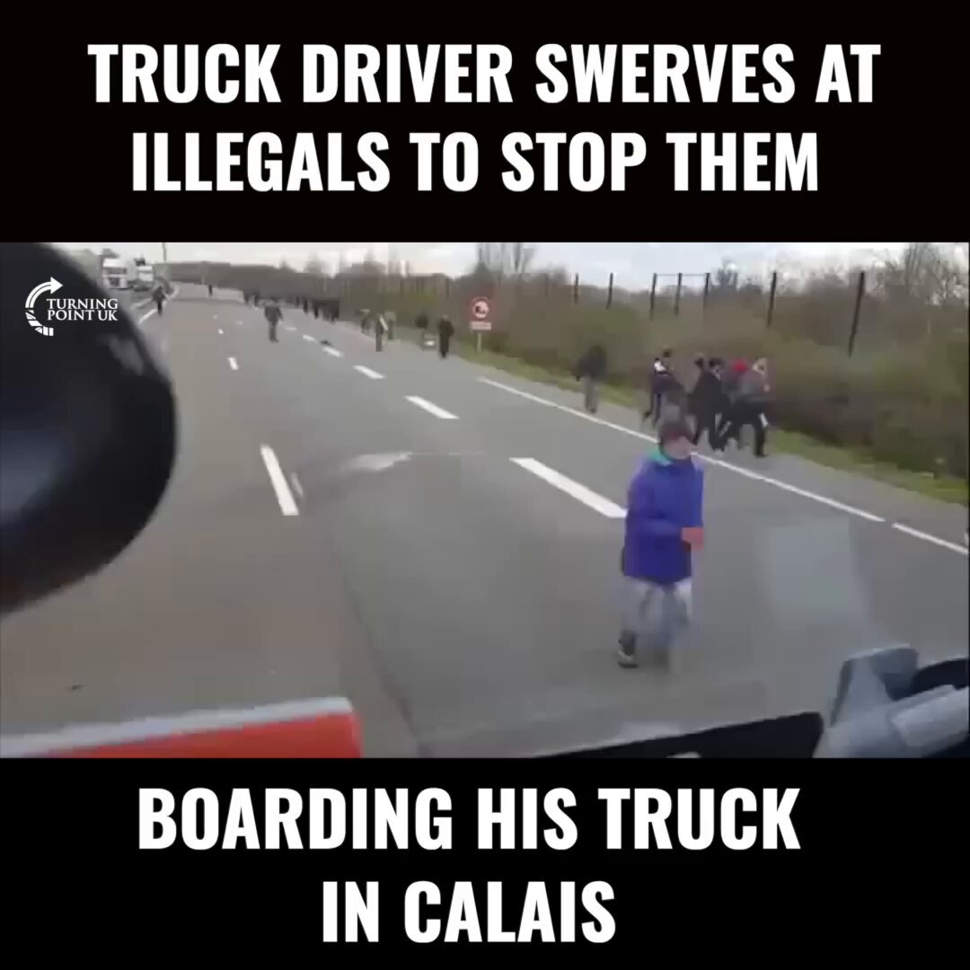 Truck driver swerves at illegals to stop them boarding his truck in Calais.