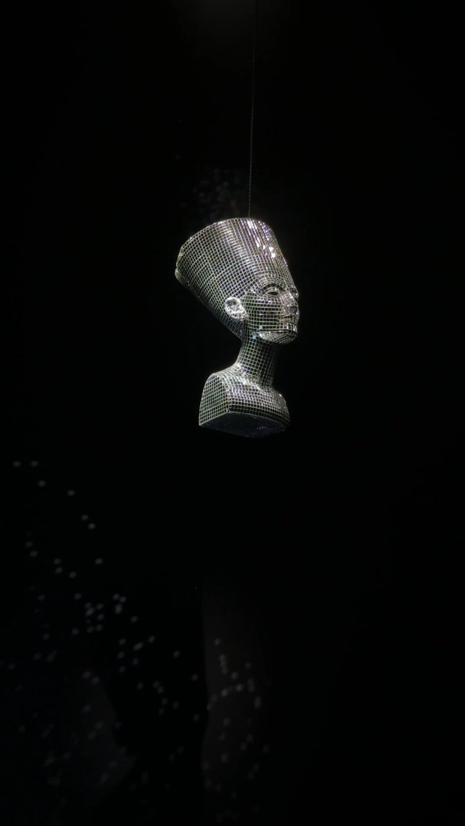 Happy New Year from The Met! 🪩 Start 2025 with a closer look at Awol Erizku's dazzling "Nefertiti–Miles Davis," a mirrored tile bust of the Egyptian queen inspired by Miles Davis’s 1968 album Nefertiti. Suspended from the ceiling and rotating like a disco ball, this work explores the intersection of music and visual art, highlighting diasporic connections to ancient Egypt. Erizku frequently features Nefertiti in his work, blending references from culture coded as "urban" and the art-historical canon to examine themes of race, identity, and history. 🎨 Awol Erizku (Ethiopian American, 1988). Nefertiti–Miles Davis, 2017. Hand-coated foam and mirrored tile.