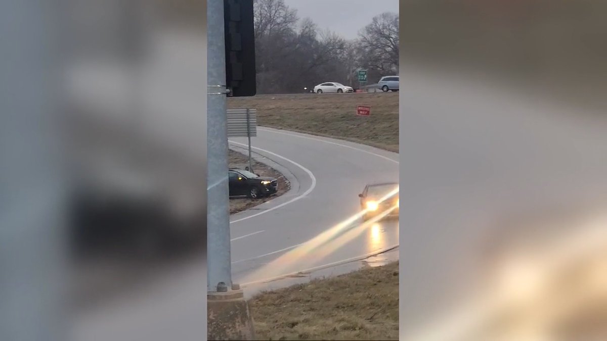 Video shows a driver bailing out after hitting black ice on an interstate off-ramp.