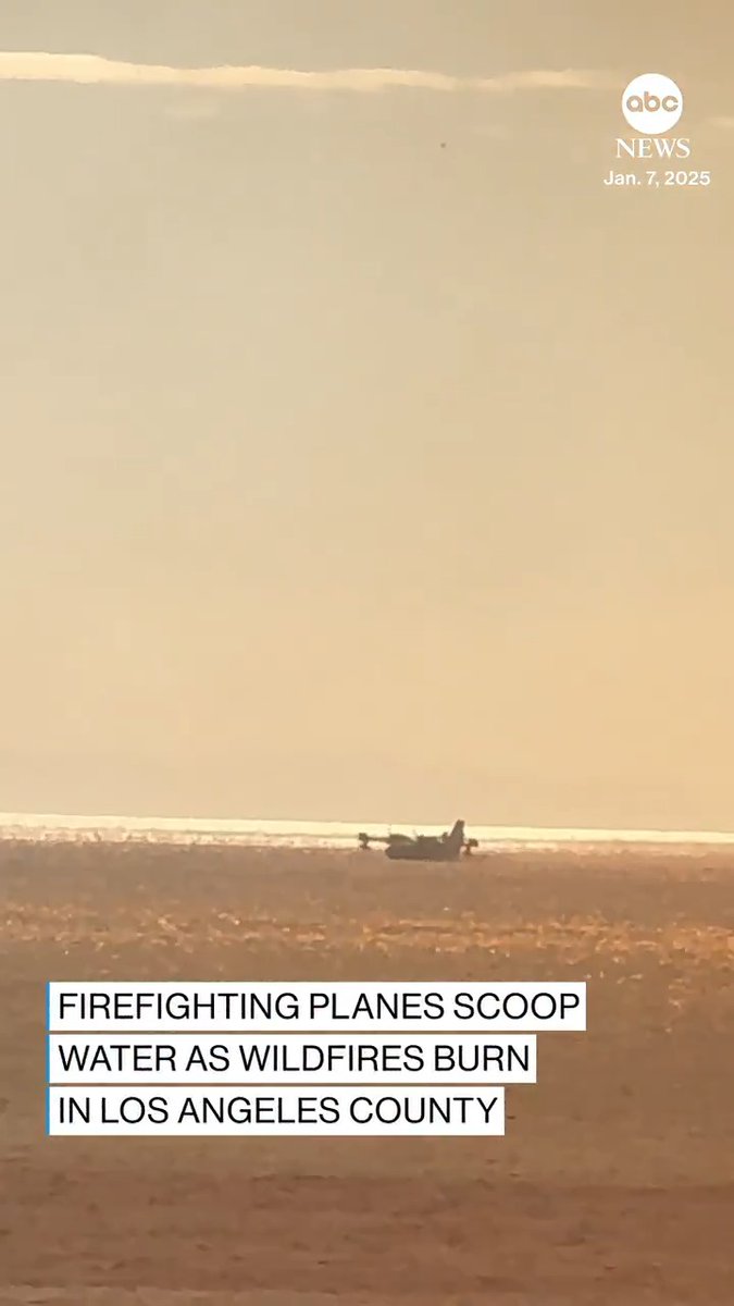 Bystander footage captures firefighting planes picking up water from the Pacific Ocean and flying over homes in Los Angeles in an effort to battle wildfires raging in California. Follow live wildfire updates: