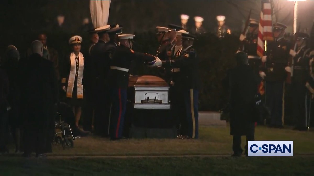 Taps is played and the American flag is folded at the grave site of President Jimmy Carter.
