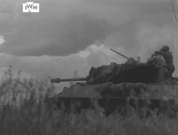 An M10 Achilles and Sherman Fireflies fire at German positions during a long-range duel near Évrecy, France, June 1944. Film: IWM A70 61-7 <1/2>