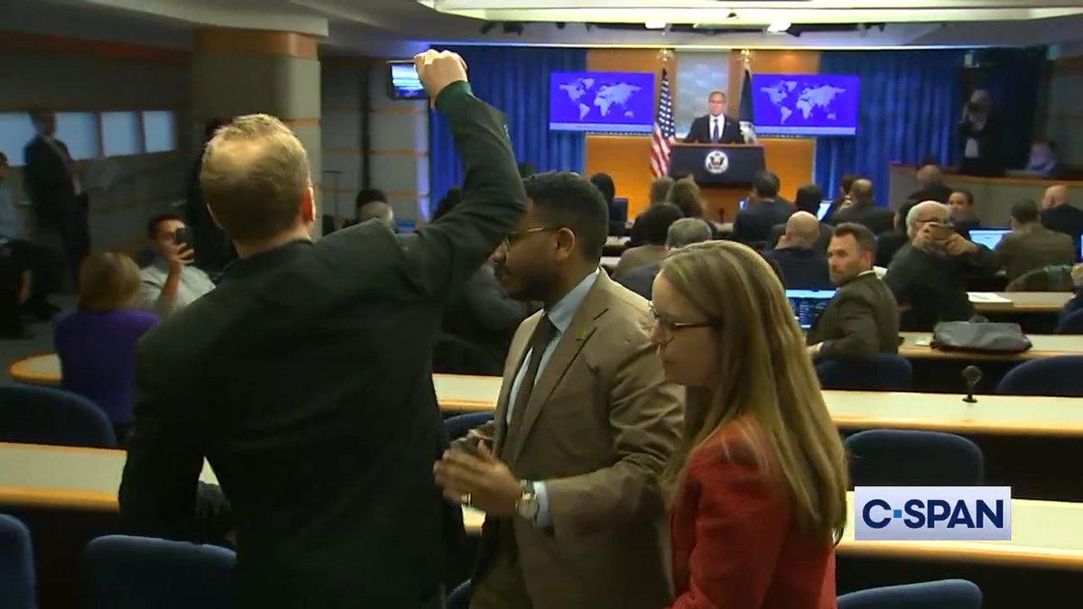 A reporter is removed after interrupting Secretary of State Blinken.