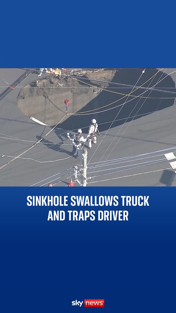 A sinkhole the size of a swimming pool opened up on a busy street in Japan, swallowing a truck and trapping the driver.