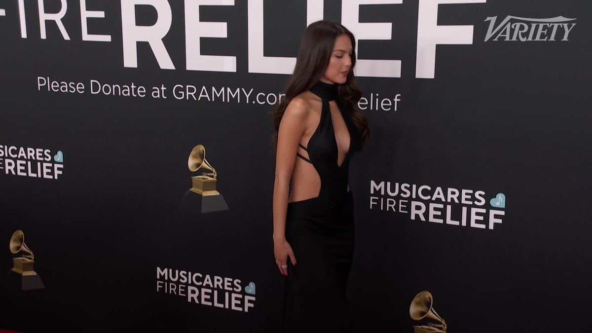 Olivia Rodrigo poses for photos on the #Grammys red carpet.