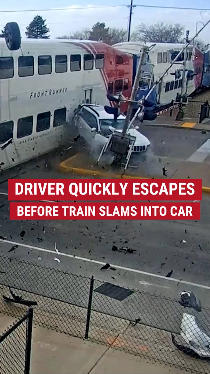 A video captured the moment a car stuck on the train tracks was slammed by a train in Utah with the driver narrowly escaping.
