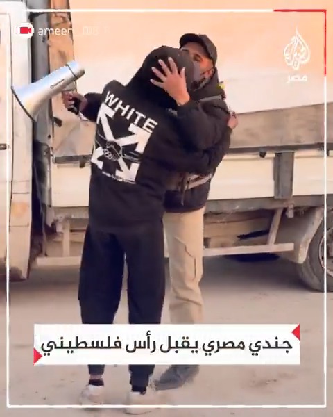 "على رأسي، واجب عليَّ أن أرى ابتسامتك وانتصارك".. جندي مصري يقبل رأس فلسطيني يهديه حلوى في #غزة