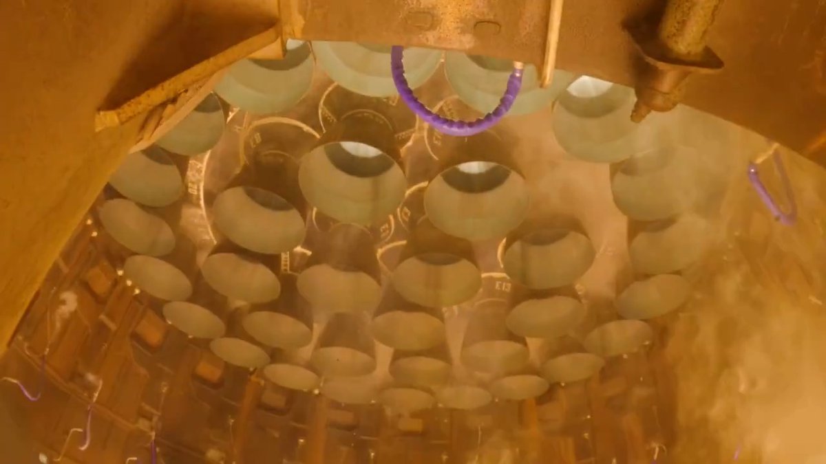 View under the launch mount as Super Heavy's 33 Raptor engines ignite on Starship's eighth flight test