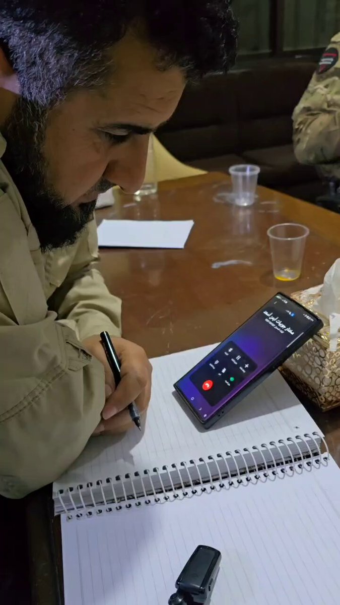 مكالمة صوتية بين الأستاذ" عامر المدني" مدير أمن في منطقة بانياس ومختار قرية جويبات " أيمن أسعد"