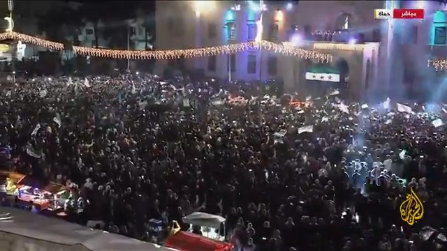 "لحظة تاريخية بالنسبة للسوريين".. كيف تبدو الأجواء الاحتفالية في مدينة حماة بذكرى الثورة السورية؟ #الأخبار #الجزيرة_سوريا
