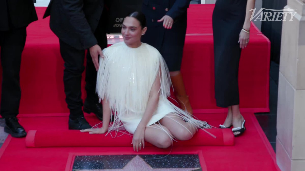 Gal Gadot poses with her star on the Hollywood Walk of Fame.