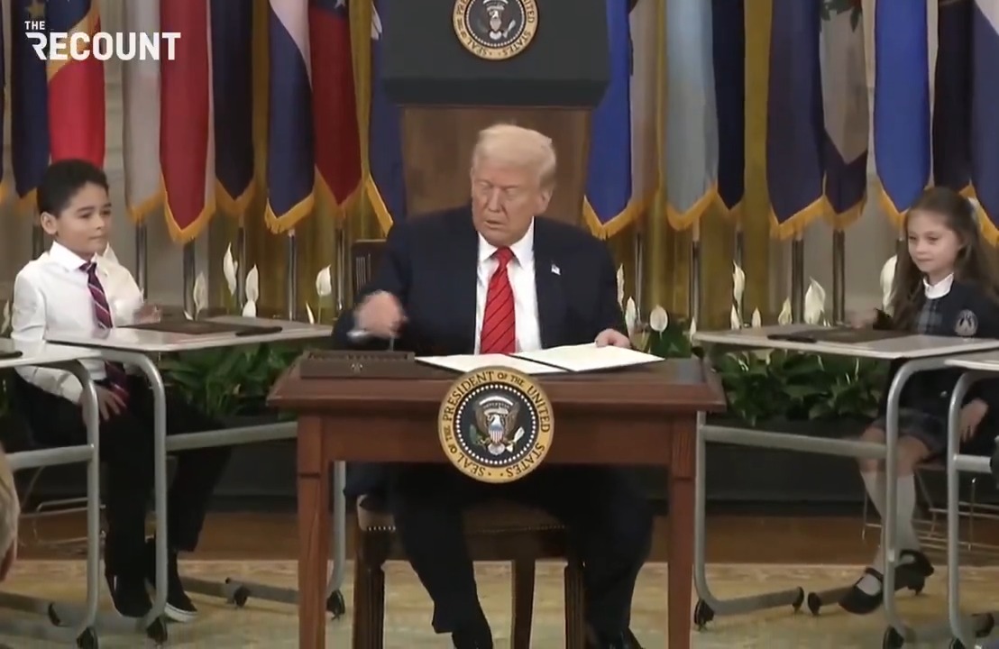President Donald Trump signs an executive order that calls for the U.S. Department of Education to be shut down — which only Congress can shutter. “Should I do this?” the president asks children positioned around him at school desks before signing the order.