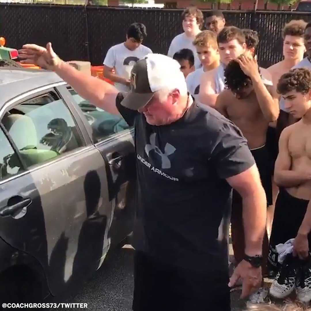 Coach teaches players how to change a flat tire after practice.
