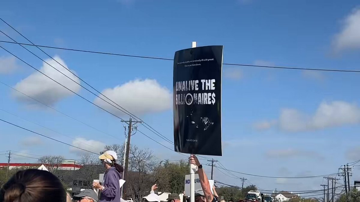 I’m currently in Austin, TX where a protestor is holding an “Unalive the billionaires” poster outside of the Tesla showroom here. This is one of the many “Tesla Takedown” protests happening across the nation today. So far protestors have called Elon a Nazi, fascist and called for him to be deported: