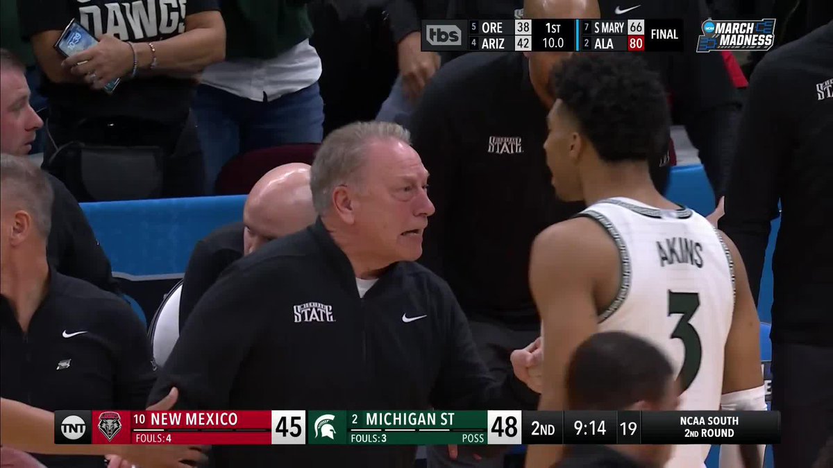 Tom Izzo and Jaden Akins exchange some words.