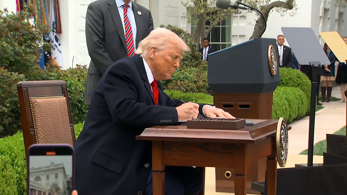 MOMENTS AGO: Trump signed two tariff documents in the Rose Garden, imposing his sweeping reciprocal tariff plan.