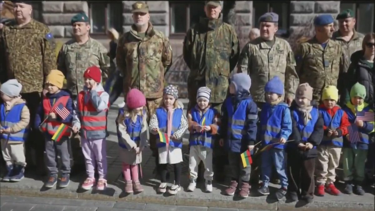 In Vilnius, schoolchildren waved U.S. and Lithuanian flags as the coffins of four American soldiers, who died in a training accident, passed through Cathedral Square in a solemn tribute.