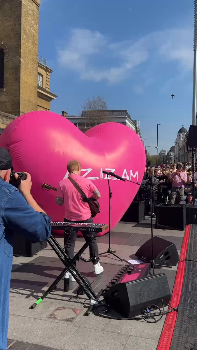 Ed Sheeran performing his new single “Azizam” outside the London Kings Cross Station.