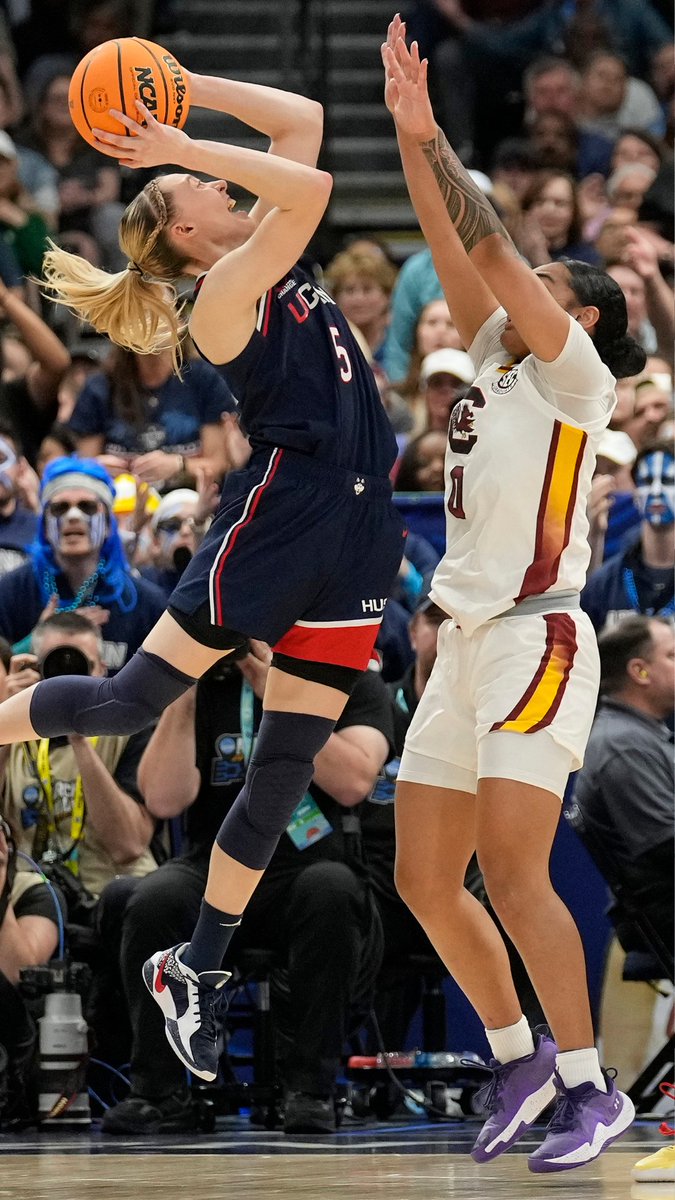 UConn reclaims the top spot in women's basketball, defeating South Carolina 82-59 to win its 12th national championship. Paige Bueckers shares feelings of joy and gratitude for the team's journey.