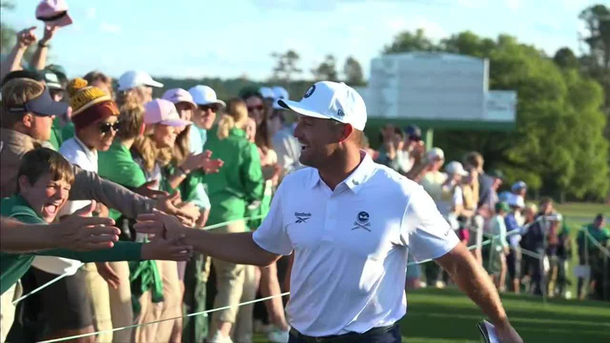 "He's trying to bring everybody with him for tomorrow." Bryson DeChambeau celebrates with the patrons after his round.