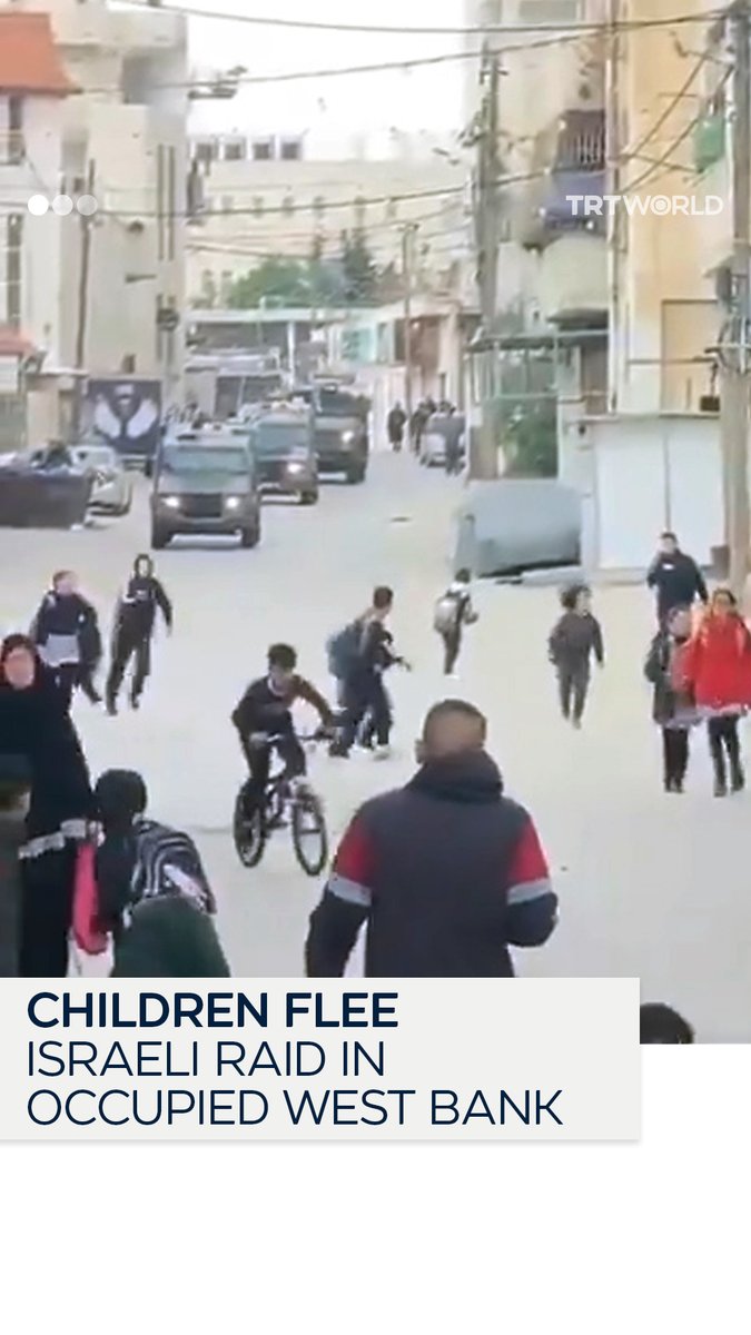 Palestinian children run in fear as Israeli vehicles storm Al-Fawwar refugee camp during a raid in Hebron, in the occupied West Bank, on April 13