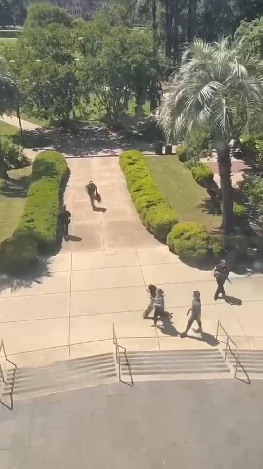 GRAPHIC VIDEO 🚨 Law enforcement seen carrying shooting victim on the scene at FSU