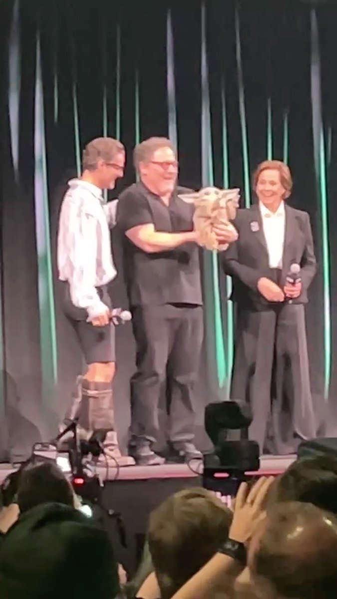 Grogu joins Pedro Pascal, Jon Favreau, and Sigourney Weaver on stage at #StarWarsCelebration.
