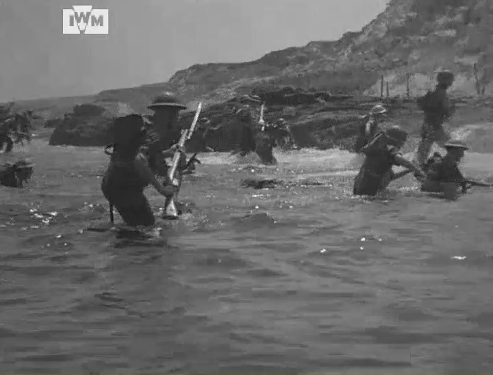 Men from the 2nd Battalion, Buffs wade ashore during a beach landing exercise in Tripoli in preparation for the invasion of Sicily, July 1943. Film: IWM AYY 493/5