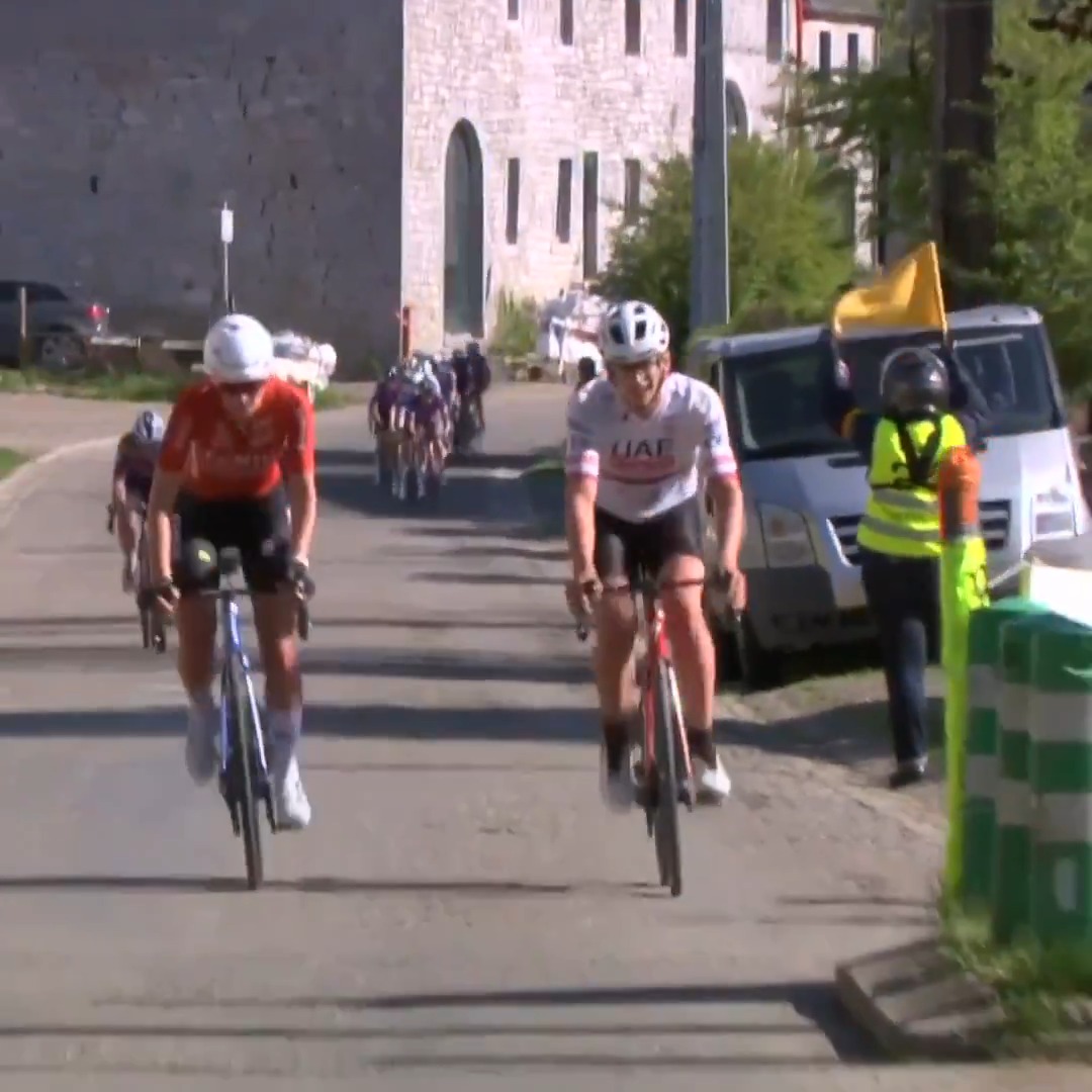 A fan rides from the side of the road onto the wheel of the race leader at Liege-Bastogne-Liege Femmes. 📺: Peacock