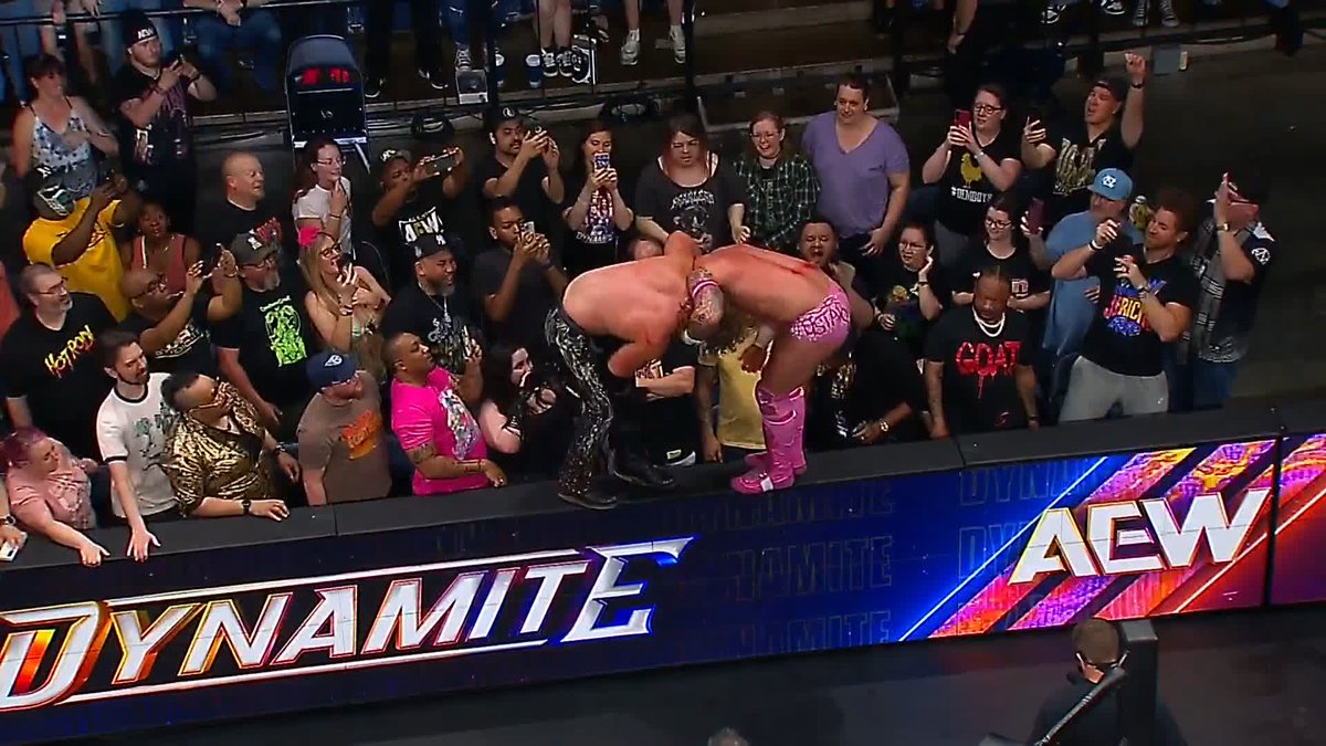 Hangman backflips off the barricade, catches Fletcher, and spikes him with a tombstone on the floor!! INCREDIBLE!! #AEWDynamite