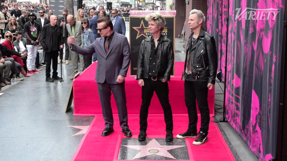 Green Day poses for photos by their newly unveiled star on the Hollywood Walk of Fame.