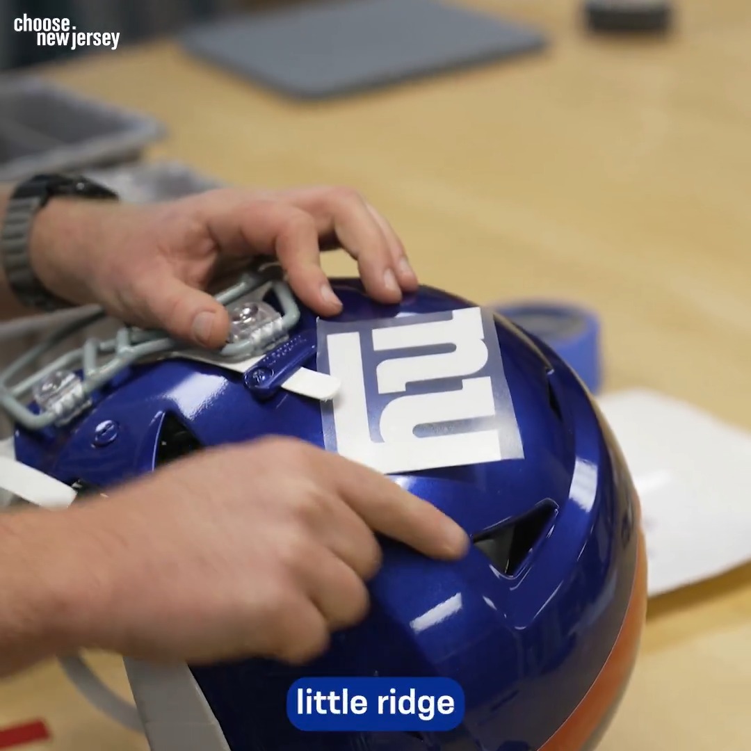 The process of prepping Jaxson Dart's helmet