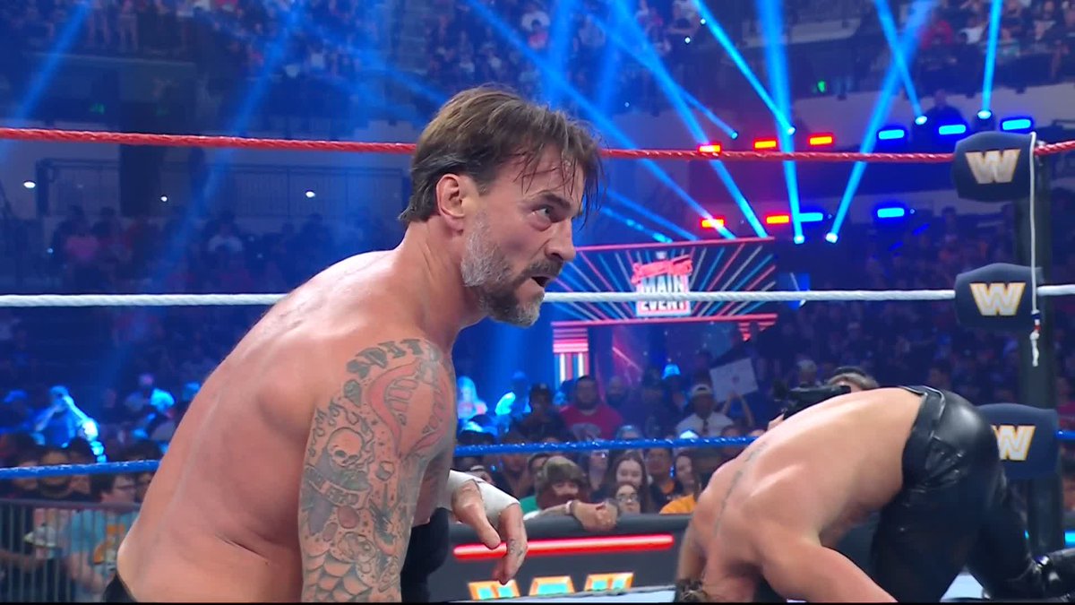 CM PUNK'S TAGGED IN AND HE'S GOING STRAIGHT FOR ROLLINS! 😤 #SNME