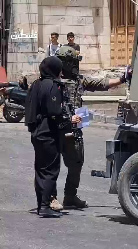 Israeli occupation soldiers detain a female worker after raiding the Al-Khaleej Exchange in the center of Hebron, south of occupied West Bank.