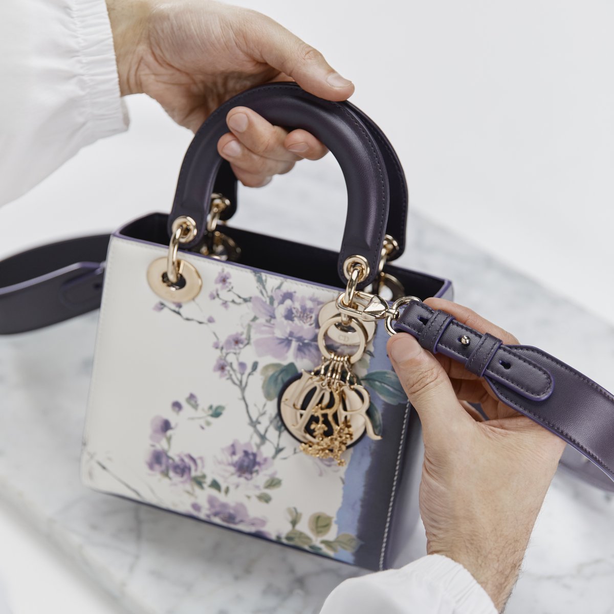 The #LadyDior bag evokes a Japanese garden for #DiorFall25, debuting in Cherry Blossom and ABC Dior Peonies, crafted through the artistry of #DiorSavoirFaire under Maria Grazia Chiuri's direction.