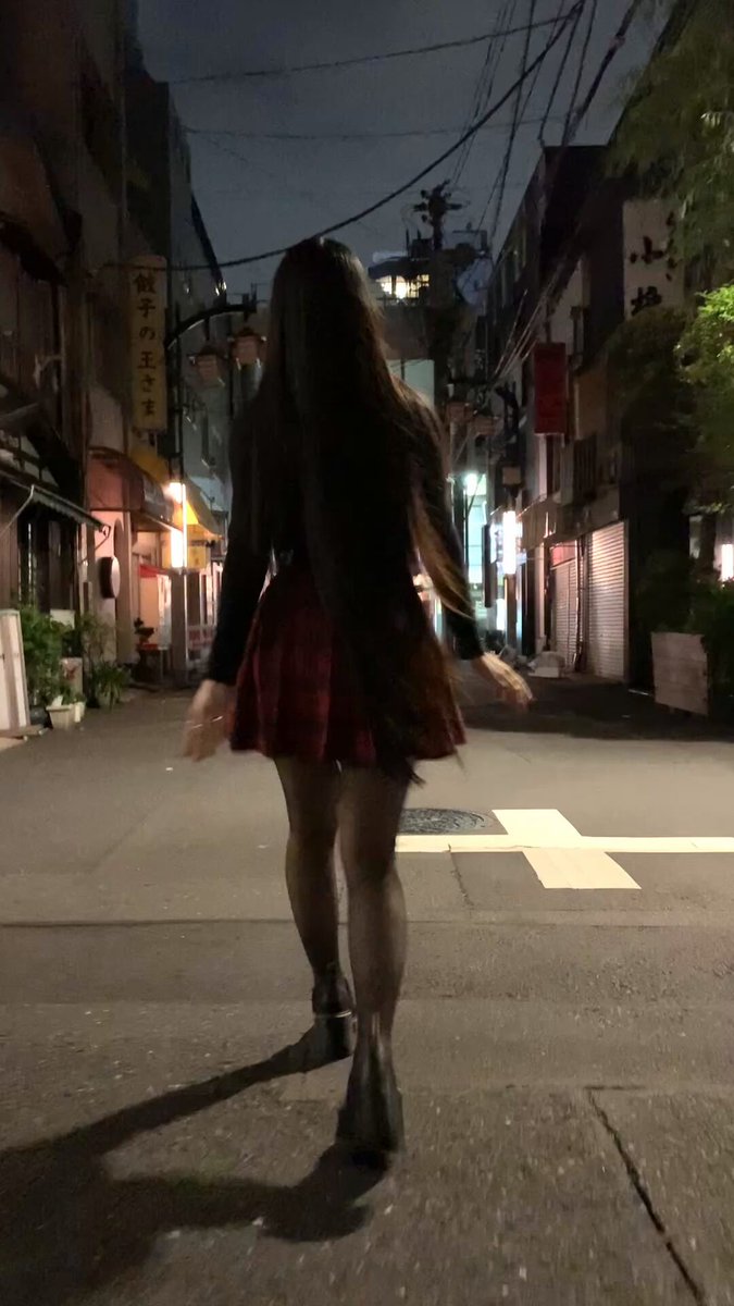 a video of a japanese girl walking through tokyo at midnight
