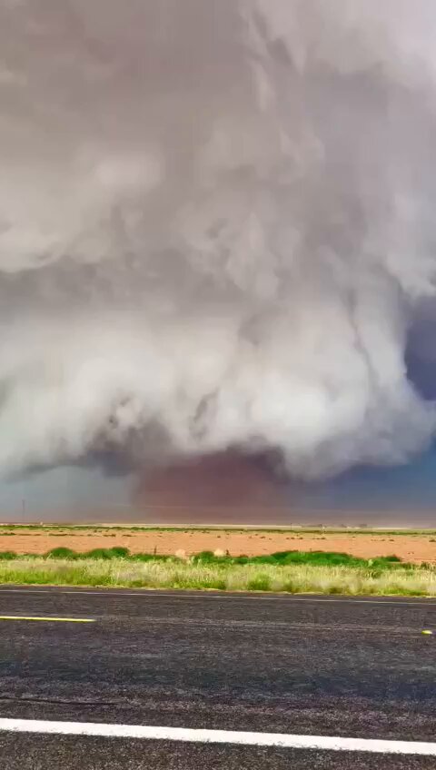 🇺🇸 TEXAS TORNADO: MASSIVE FUNNEL TEARS THROUGH LUBBOCK AREA A massive wedge tornado touched down northwest of Lubbock, Texas, causing structural damage and knocking down trees. Dramatic footage shows the tornado on the ground west of Morton. Reports of softball-sized hail add to the severity of this extreme weather event. Meteorologists confirmed the scale of the storm, noting its impact as it moves through the region. Emergency crews are responding to the damage, while residents remain alert for further severe weather. Source: Reed Timmer, PhD