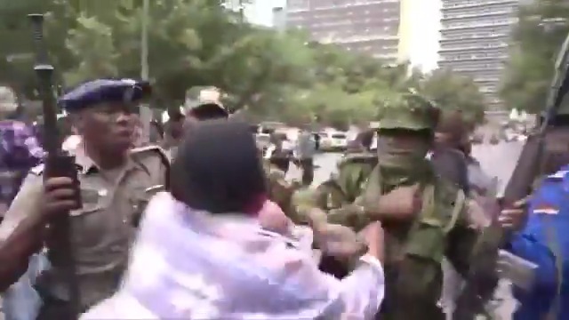Please tell me this isn’t real. Is this woman actually fighting five armed police officers?
