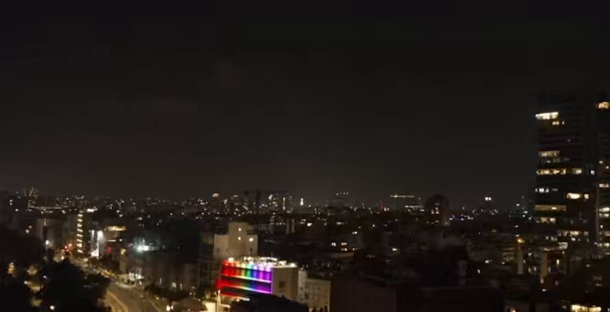 Live streams from Tel Aviv, Israel, show incoming missiles and air defense active.