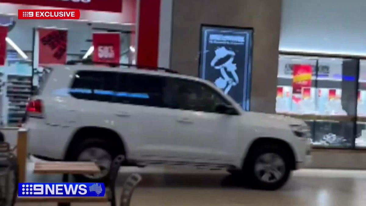 A fugitive driver in a stolen LandCruiser has barrelled into Northland Shopping Centre, ploughing through one entrance before speeding out the other side. The vehicle still remains at large. #9News