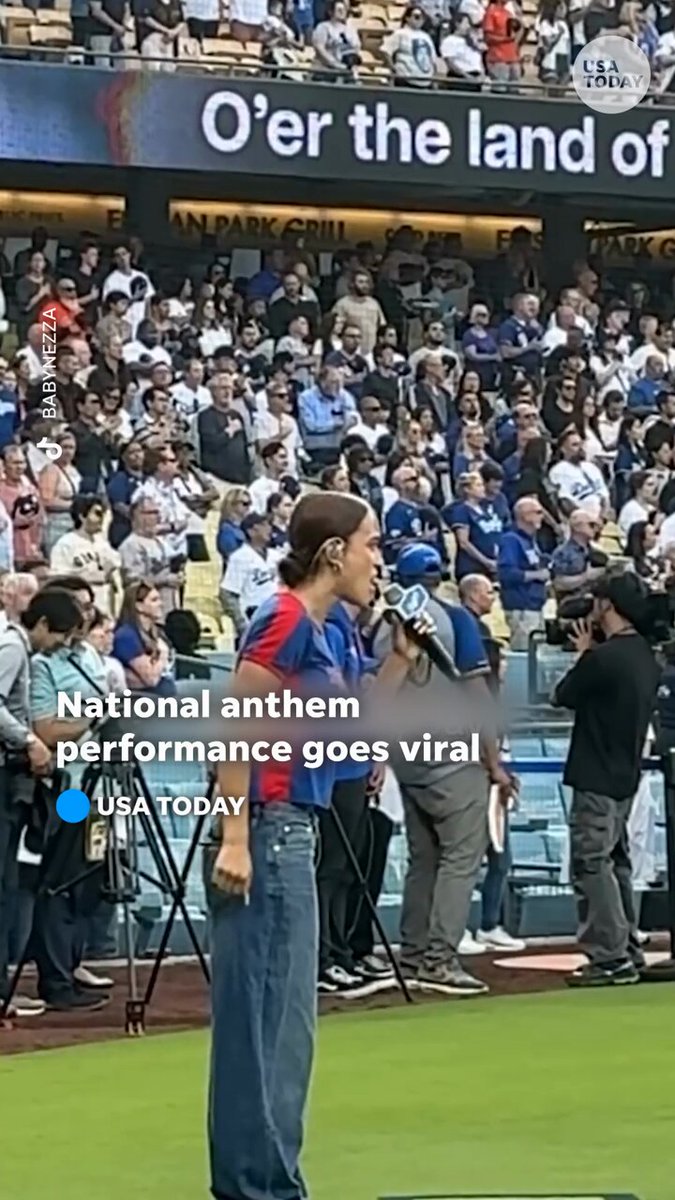 "Para mi gente." Singer Nezza says she ignored requests to sing the national anthem in English at an LA Dodgers game. See her now viral rendition.