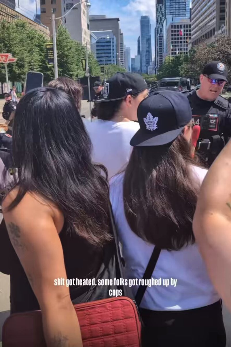 The protester dressed in red who gets jostled by police and arrested in the background is embedded within the same network as Gisela McKay. 📸 Jul 1, 2025 #Toronto #ProtestMania