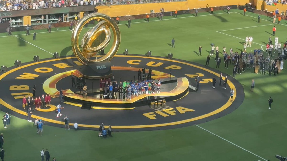Chelsea lift the inaugural expanded Club World Cup trophy. Amazingly, President Donald Trump stays in the team huddle and lifts it with them! 🏆