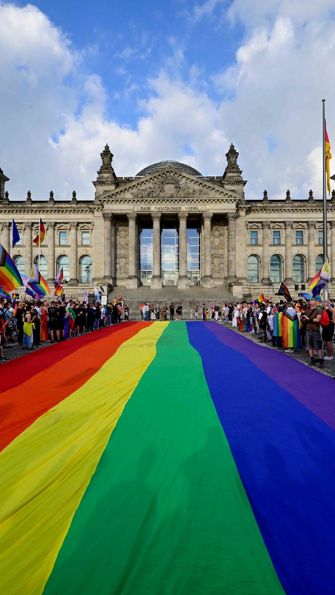 LGBTQ+ activists rolled out a giant rainbow flag in front of the German parliament to protest the government's decision not to hoist an official rainbow flag for Pride month this year.