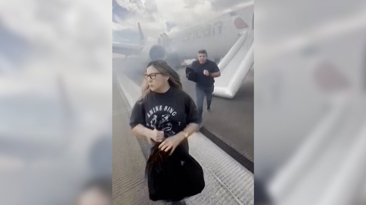 Watch terrifying moments on the tarmac: American Airline passengers were forced to evacuate using the emergency slides after the plane blew a tire during takeoff.